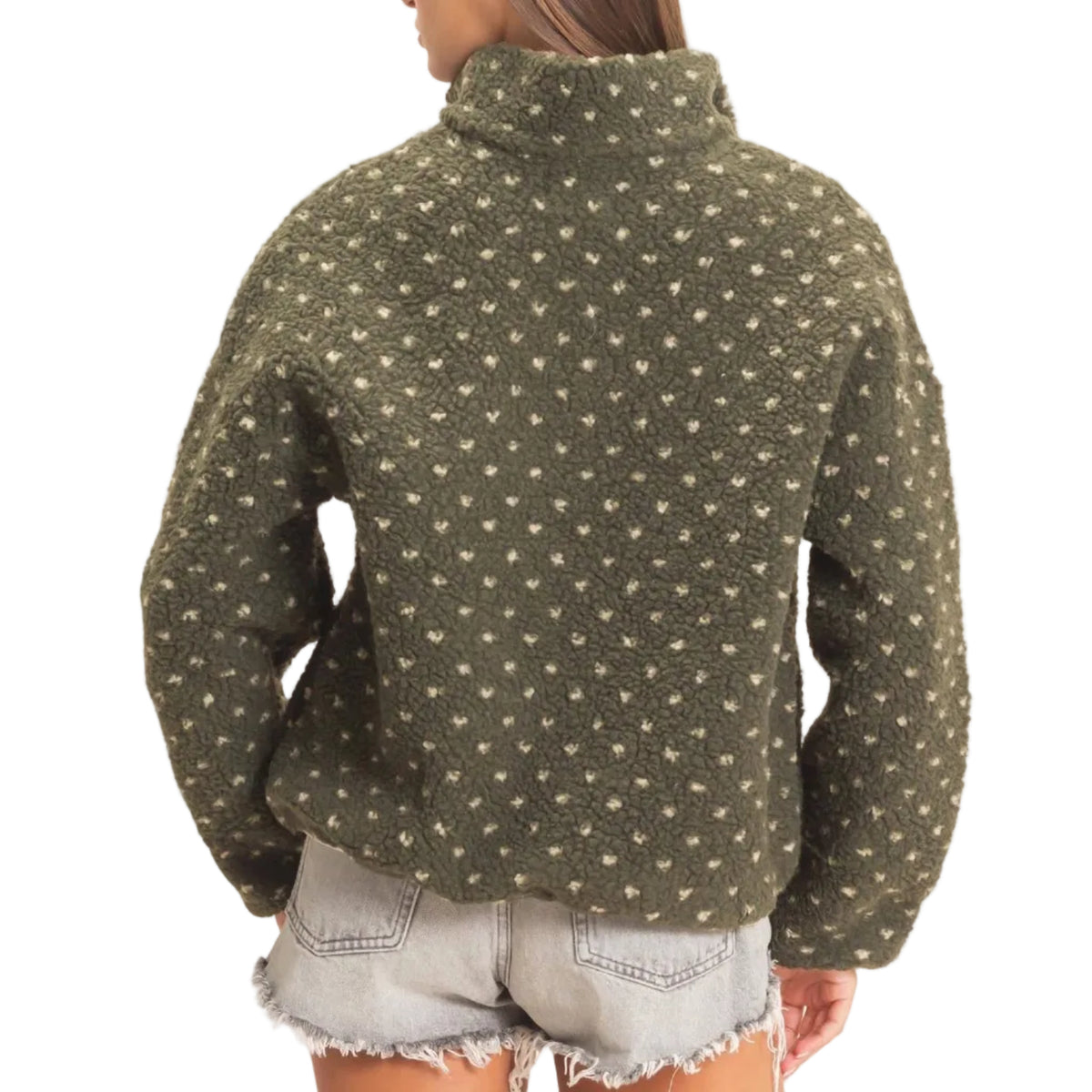 A woman shown from the back wearing an olive green textured fleece pullover with a small beige floral pattern, paired with light denim shorts, against a plain off-white background.